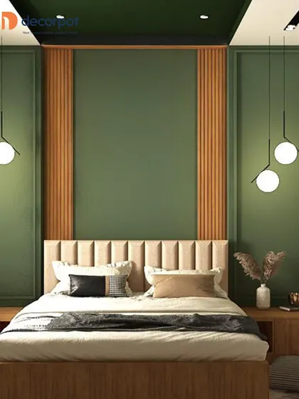 This version of the bedroom shows how a bold color can transform the space. The deep green accent wall provides a dramatic backdrop for the neutral upholstered headboard and wooden furniture.