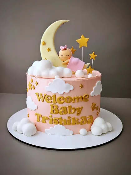 And they welcomed their lil princess, Trishikaa. This blueberry cake features a sleeping baby on a crescent moon, surrounded by fluffy clouds and stars.