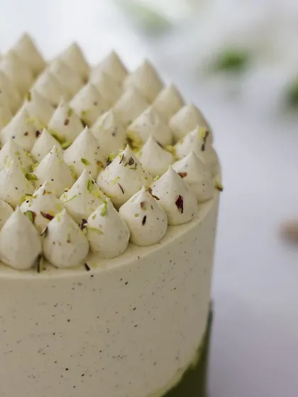We craft a uniquely sophisticated flavor profile with our pistachio custard cake. The subtle green hue and piped cream topping create an elegant and understated design, perfect for celebrating Mother's Day with a gourmet touch.