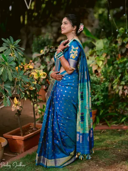 A beautiful solo portrait of the bride-to-be, Tanuja, in her vibrant blue saree.
