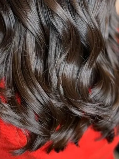 Embracing the artistry of balayage with these deep, rich tones and soft waves.