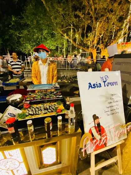 My 'Asia Town' live station offers a taste of the Orient. This setup features a variety of Asian specialties, including freshly rolled sushi, providing a sophisticated culinary experience.