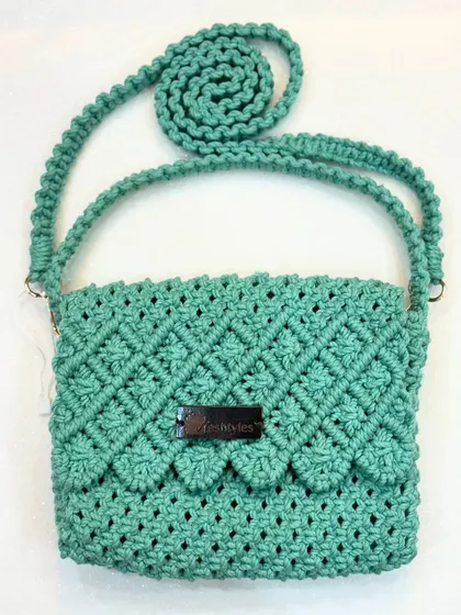 This mint green sling bag with a scalloped flap is ready to find a new home. The color is so refreshing!