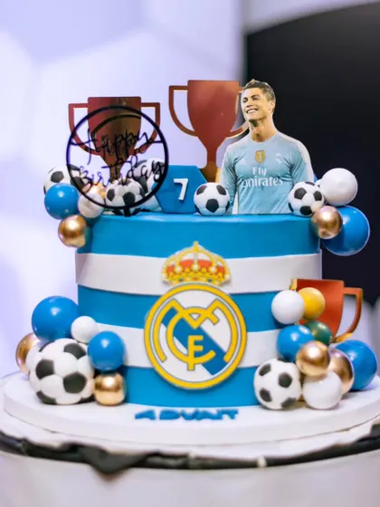 A cake fit for a football legend! This Ronaldo-inspired cake in Real Madrid's white and blue was a showstopper for a young fan's birthday.
