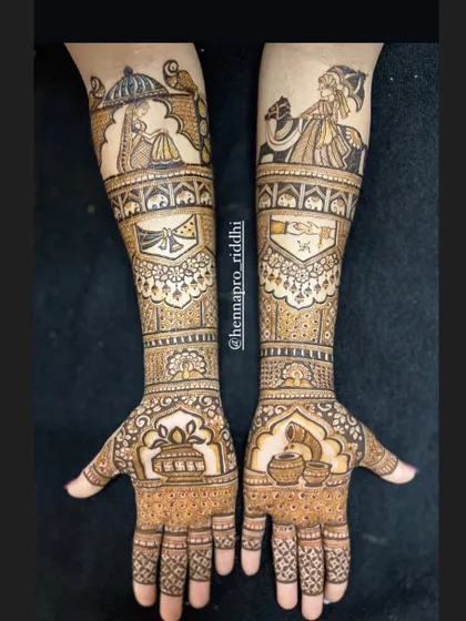 A complete traditional bridal henna design. It includes the doli and baraat procession on the forearms, with auspicious symbols like the kalash and swastika integrated into the pattern.