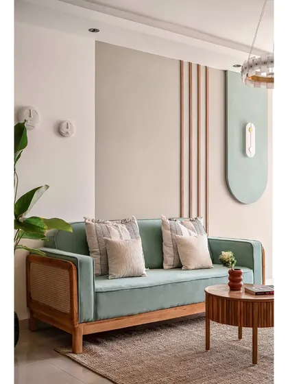 In 'The Boho Escape', the living room features a mint green sofa with cane details and a textured back wall. The design uses natural materials and soft colors to create a tranquil, bohemian-inspired atmosphere.