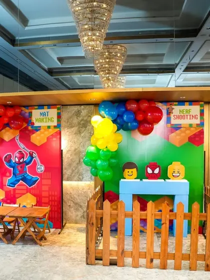 A wide view of the LEGO-themed game stalls, showing how we use picket fences to create an organized and safe play area.