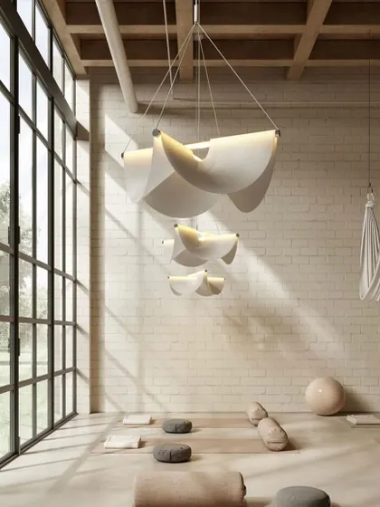 A cluster of Drape Lights in a yoga studio. Their soft, serene forms and warm, downward light contribute to the calm and peaceful atmosphere of the space.