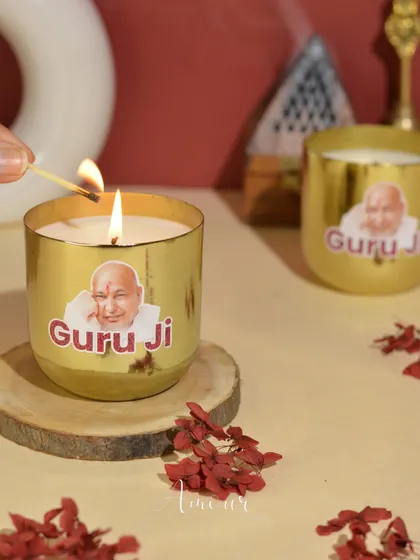 A close-up of my 'Jai Guruji' candle in a golden metal jar, a perfect spiritual gift to start the year with blessings and gratitude.