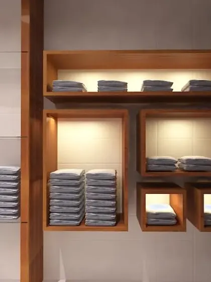 This image details the custom shelving units designed for a retail space. The combination of open glass shelves and illuminated wooden boxes provides a versatile and visually appealing display solution for various products.