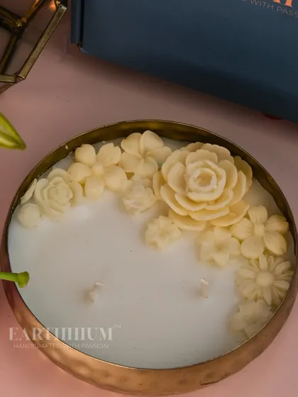 For a more subtle and elegant look, I designed this Urli candle with creamy white florals. It's a timeless piece that adds a touch of understated beauty to your space.