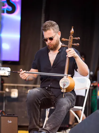 We bring in unique instrumentalists to enrich the sound. Here's a musician playing the esraj, adding a soulful, melodic layer to the performance.