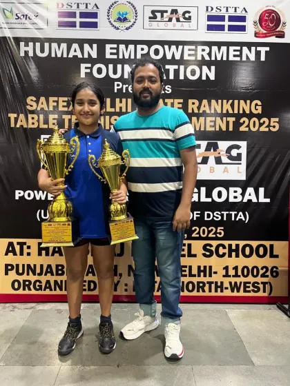 Coach celebrating with Akanksha Singhal after her stellar performance at the 3rd Delhi State Ranking Tournament, where she won a gold and silver medal. This partnership between player and coach is key to our success.