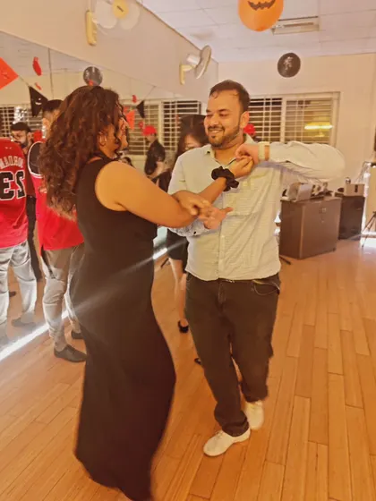 A candid moment of laughter and dancing at our studio social. It's these moments that build our community.
