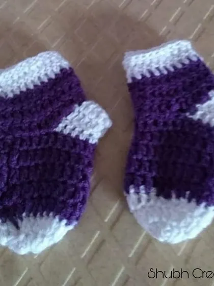 A pair of purple and white baby socks, perfect for keeping tiny feet warm.