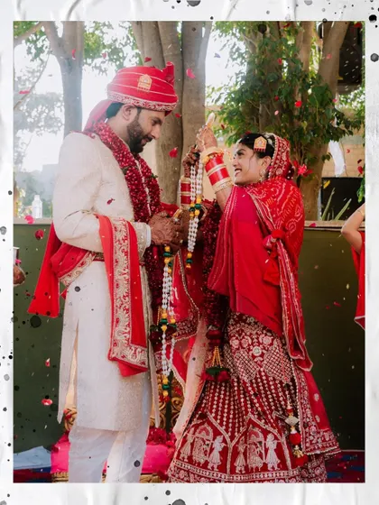 A beautiful, artistic shot of the couple during their 'Varmala' exchange.