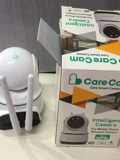 The Care Cam shown next to its packaging. This intelligent camera is a popular choice for families wanting to stay connected and ensure their home is protected 24/7.