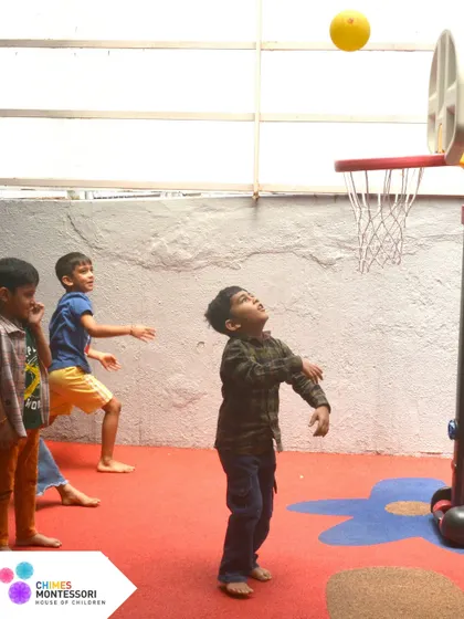 Play isn't just play, it's their work. A child enjoys a game of basketball, developing gross motor skills and coordination.