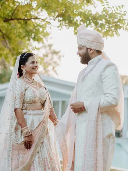 A beautiful, happy portrait of the couple in their wedding attire, sharing a sweet, candid moment.
