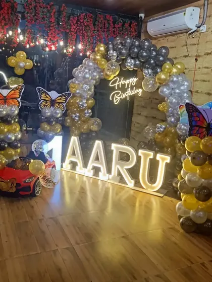 A full view of the stylish butterfly-themed setup for Aaru's first birthday.