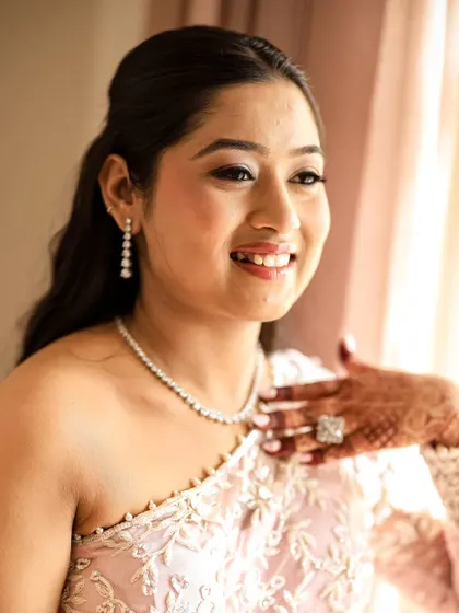 A beautiful, sun-kissed portrait of the bride, her face lit up with a happy smile.