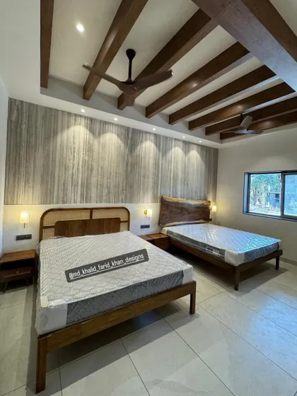 A hotel room I recently furnished, featuring two different bed designs. One bed has a cane and wood headboard, while the other has a live-edge solid wood headboard, showcasing my versatility in custom designs.
