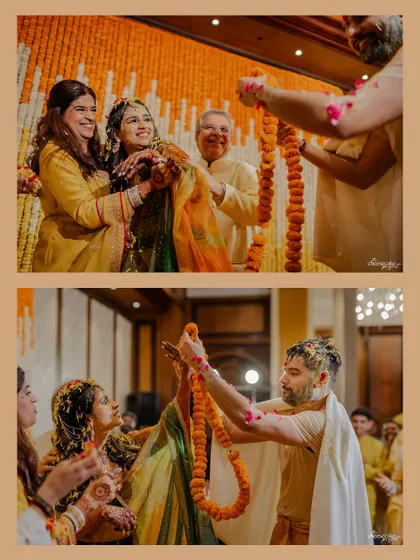 Family members lovingly putting a marigold garland on the couple during the Haldi rituals.