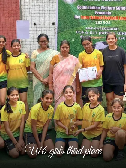 The Shishuvan U16 girls' team proudly accepts their third-place trophy at the Inter-School Football League, a testament to their grit and our coaching.
