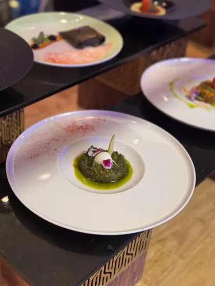 A vibrant green puree forms the base for this intricately constructed bite. The dish is a study in colour and form, showing how we use natural ingredients to create visually arresting plates.