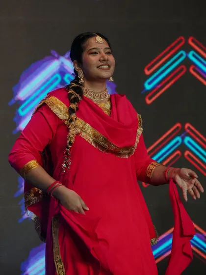 A student performs a traditional Punjabi dance, bringing vibrant cultural energy to the stage.