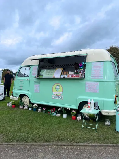 More glimpses of the English countryside celebration, showing the floral-draped entrance, the grand marquee tent, and the charming ice cream truck.