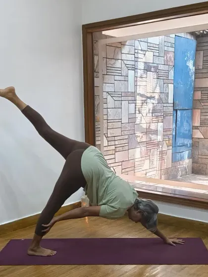 Finding harmony within ourselves is the true goal of yoga. This revolved downward facing dog pose is a beautiful expression of balance and strength, showing how we can find stability even in a twist.