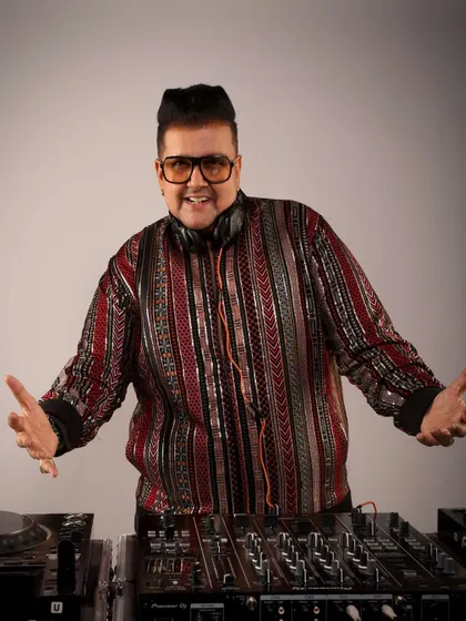 A full shot of me at the console in a stylish, patterned jacket. Fashion is a big part of my identity as a performer.
