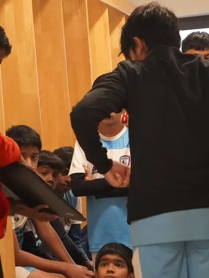 The coach uses a whiteboard to illustrate game strategy, ensuring every player understands their role.