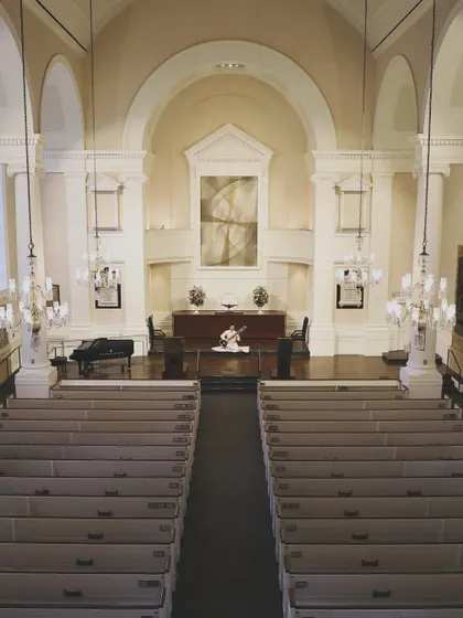 The empty hall at All Souls NYC, showcasing the beautiful, serene space before guests arrive. I can transform any venue into a space for peace and reflection.