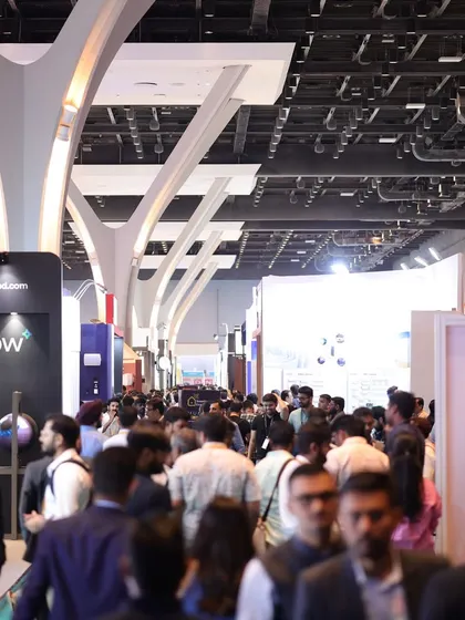 A view down a packed aisle of the Jio World Convention Centre, capturing the immense scale and high footfall that exhibitors can expect at our event.