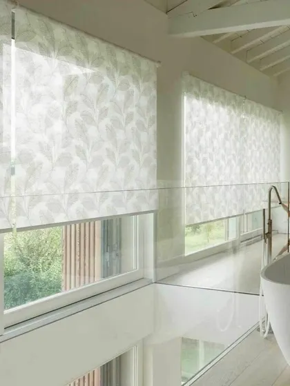 Another view of the light-filtering roller blinds with a leaf pattern, demonstrating their elegant and practical use in a bright, modern bathroom.