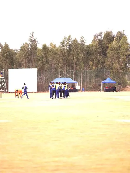 A duplicate wide shot of the cricket ground setup, showing the scale of the event.
