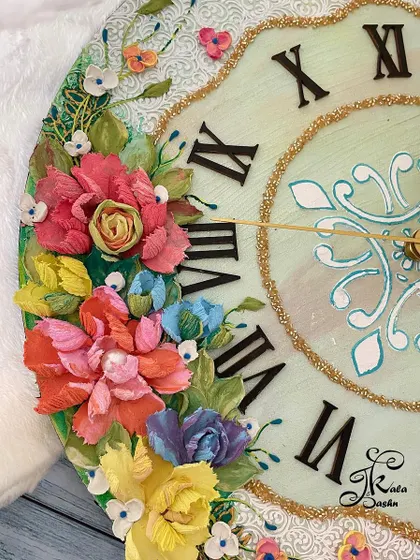 A close-up of the multi-colored flowers on a 14-inch wall clock with a neutral base and elegant white textured border.
