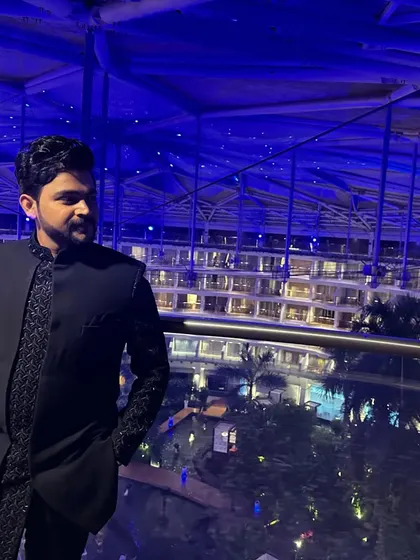 Another angle of the blue Indo-Western outfit with salli work, showing how the structured jacket creates a modern and flattering silhouette against a city backdrop.