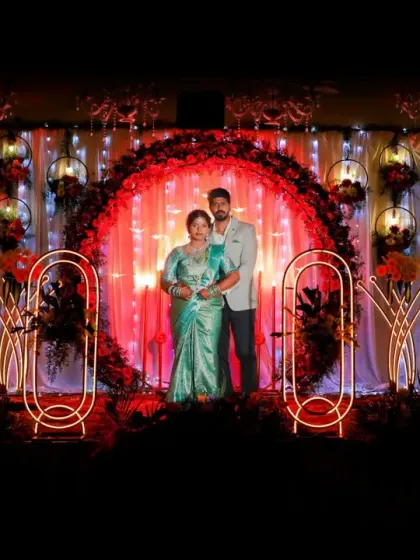 A wide shot of the couple on their beautifully decorated engagement stage, showcasing the event's ambiance.