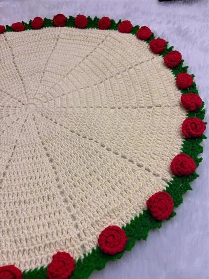 Here is the rose blanket laid flat, showing the full circular design and the beautiful border of red roses and green leaves.