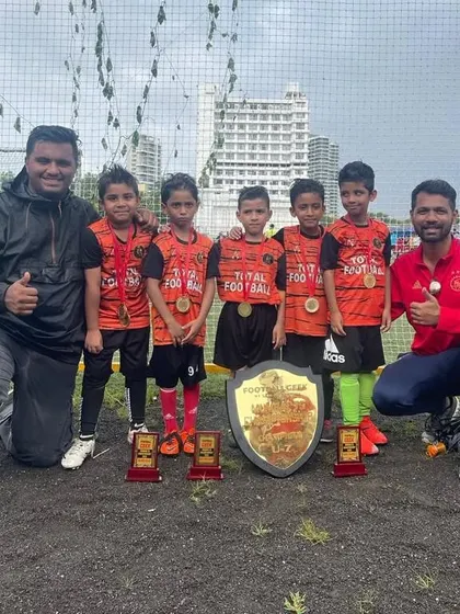 Our U7 champions posing with their coaches and trophy at the Mumbai 7s Championship Cup.