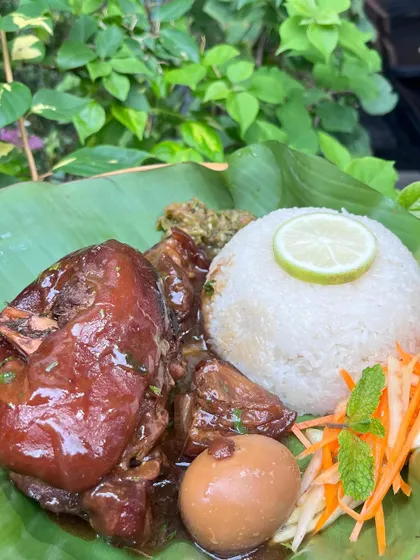 A close-up of our weekend special, the Sweet Pork Knuckles combo. The dish includes a perfectly cooked egg and sticky rice, making it a complete and satisfying meal.