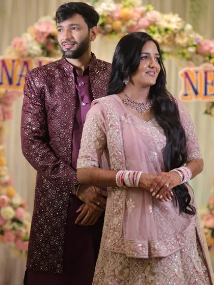 The couple posing together at their engagement. The bride's soft glam makeup looks beautiful next to the groom's coordinated attire, creating a perfect picture.