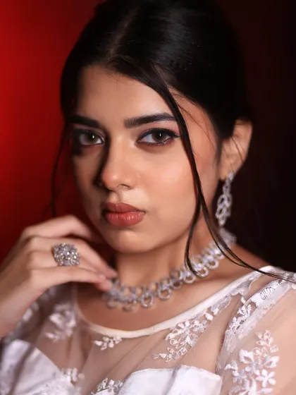 A striking close-up of a Christian bridal look. The focus is on the defined, winged eyeliner and soft nude lip, creating a modern yet timeless appeal.