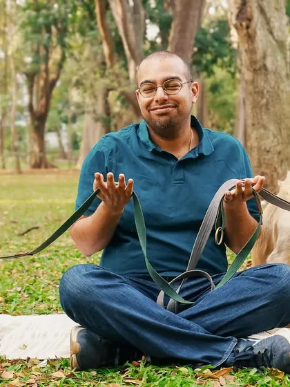 The proud dad showing off his two well-behaved Golden Retrievers. This shot captures a fun, behind-the-scenes moment from our outdoor family session.