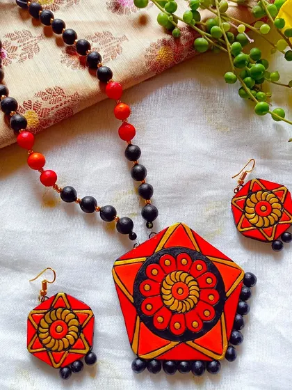 An orange and red version of the hexagonal pendant necklace, offering a warm and fiery color option.