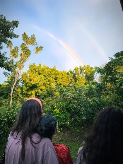 A double rainbow appears over the lush green forest of the ashram. Moments like these are a beautiful reminder of nature's harmony and wonder.