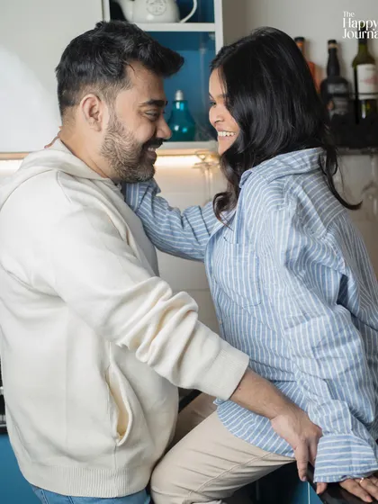 Laughter and love in a casual setting. This candid moment shows the genuine happiness of a couple on their journey to parenthood.